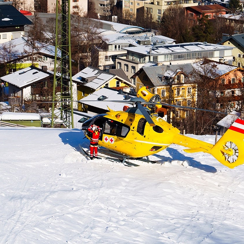 Helicopter Rescue Evacuation of Injured Skier in Snowy Mountains - Travel Insurance