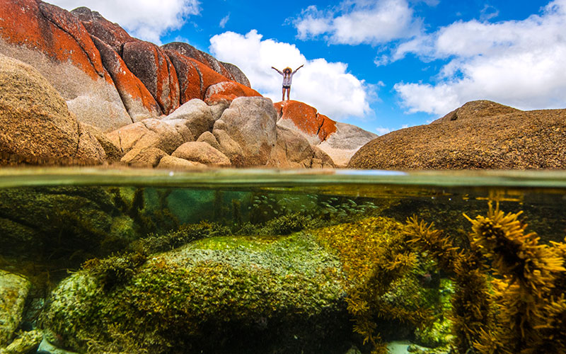 Young Woman on the Rocks in Bay of Fires, Tasmania