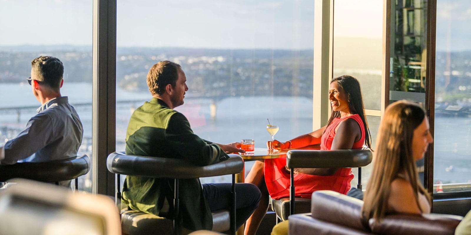 Stylish couple enjoying wine and cocktails in Auckland with a view of the Viaduct