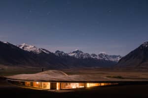 The Lindis luxury lodge under starlight, surrounded by snow-capped mountains