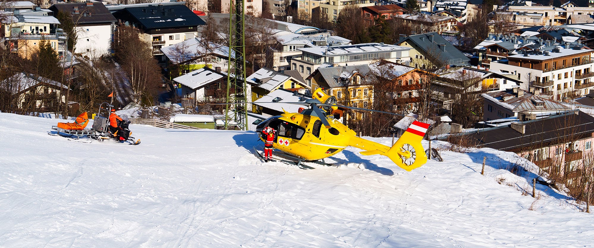 Helicopter Rescue Evacuation of Injured Skier in Snowy Mountains - Travel Insurance